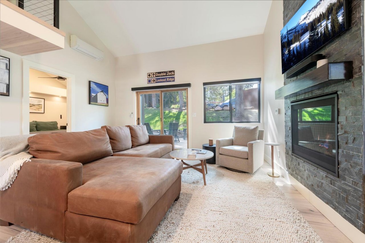 Natural light enhances the cozy living space with gas fireplace.
