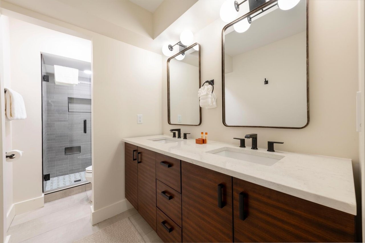 Bright master bathroom with dual vanities.