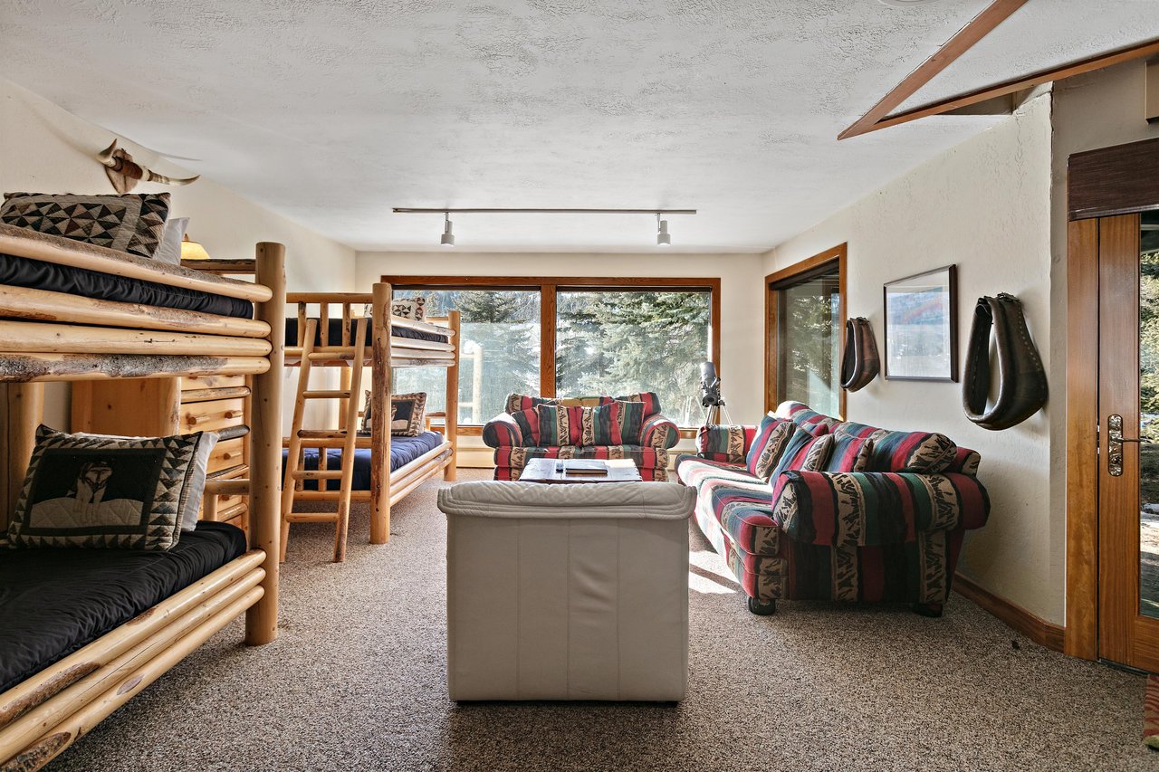 Your cozy mountain retreat features handcrafted log bunk beds with living space,  walk out to the hot tub on the deck.