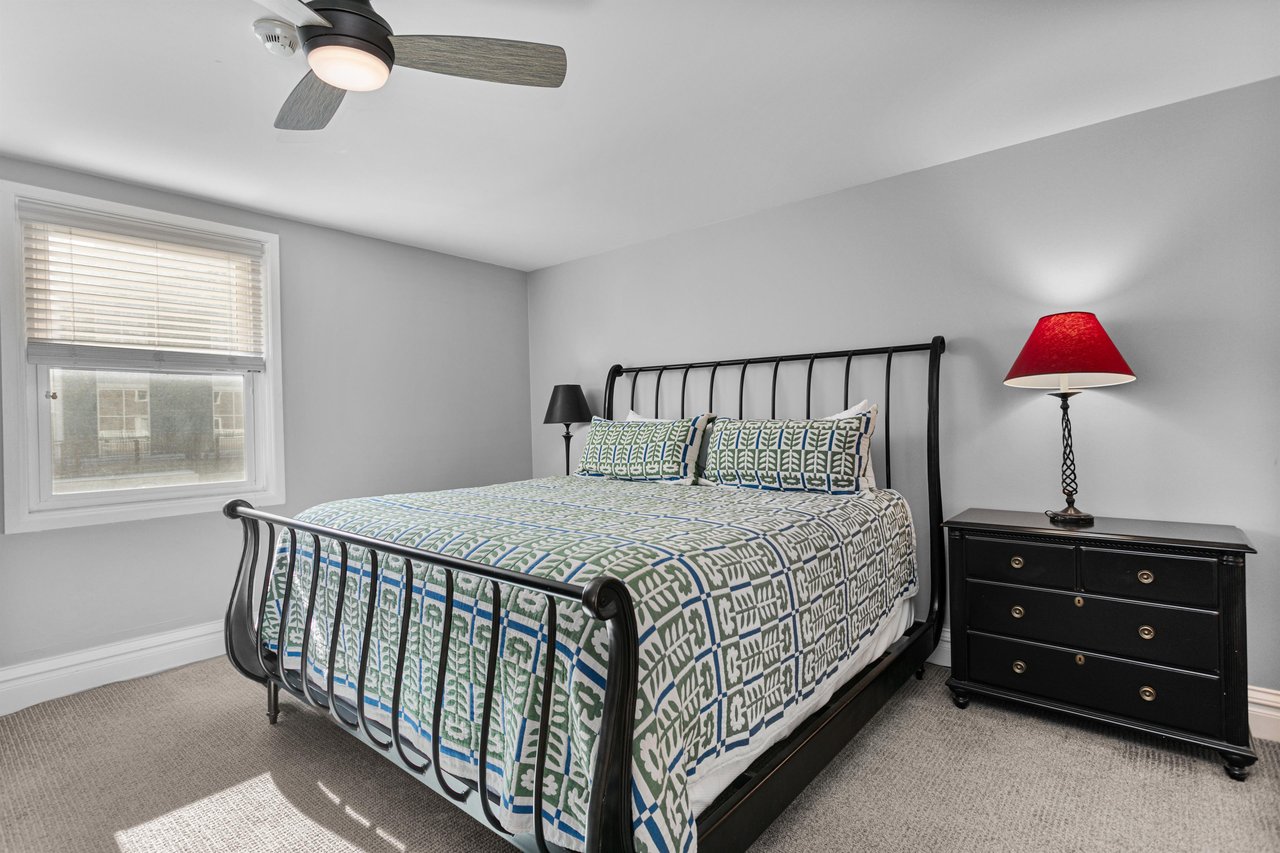 Unwind in your peaceful bedroom featuring a comfy bed, ceiling fan for cool nights, and natural light streaming through your window.