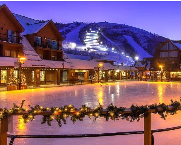 Evening magic at the Park City Resort base — the seasonal ice skating rink is just a short stroll from Lodge at Mountain Village 303, your skiinskiout home in the heart of it all.