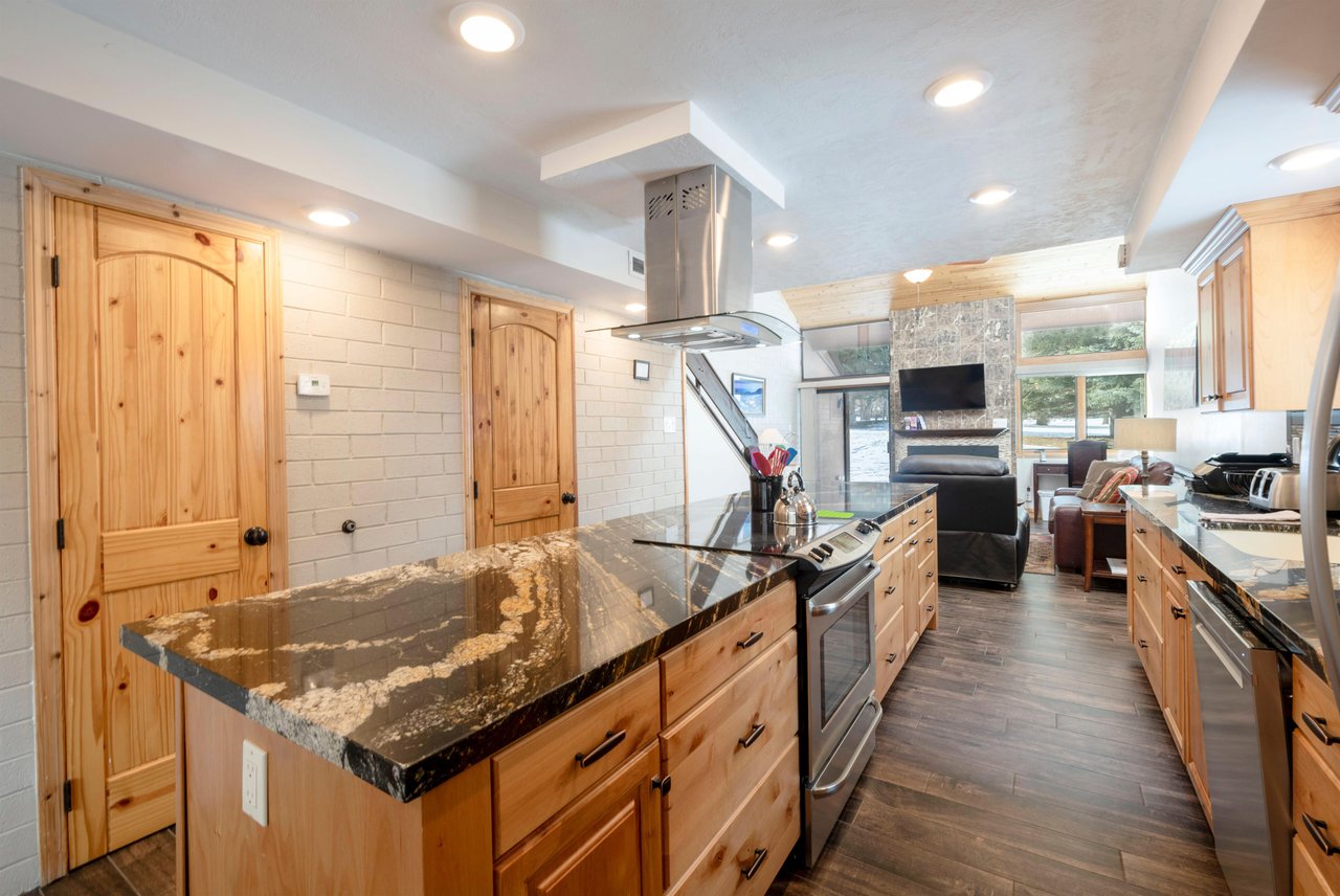 Modern appliances, granite counters, and an open flow to the living area make the kitchen at Park Avenue 235 a true centerpiece of this beautifully remodeled Park City condo.