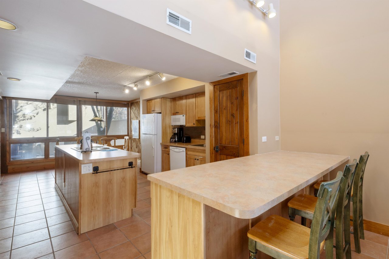 A fully equipped kitchen with ample counter space and a breakfast bar — everything you need to cook, gather, and enjoy your stay at this Park City vacation rental.