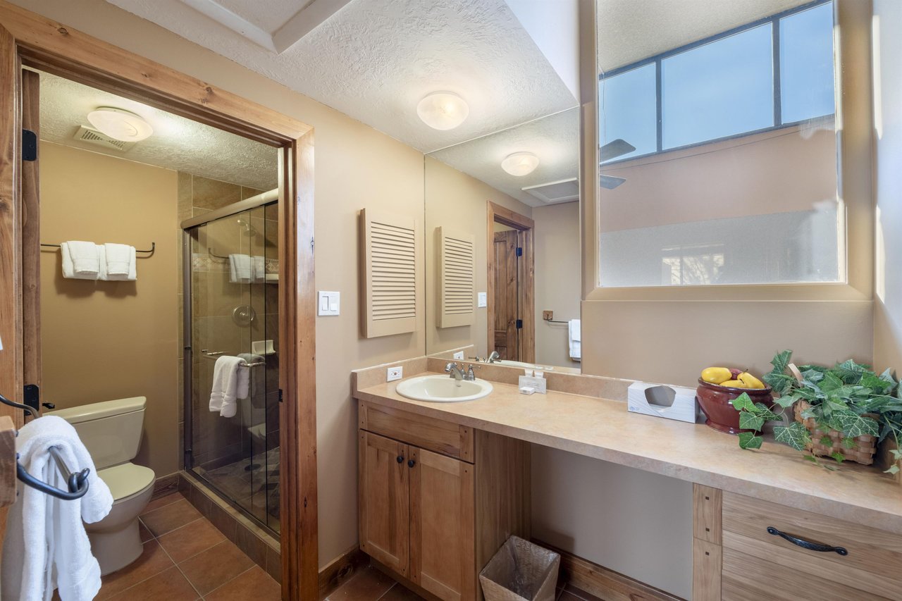 The second bathroom at Park Avenue 224 features a walkin shower and wood vanity — a clean, functional space that keeps your group moving smoothly at this Park City vacation rental.