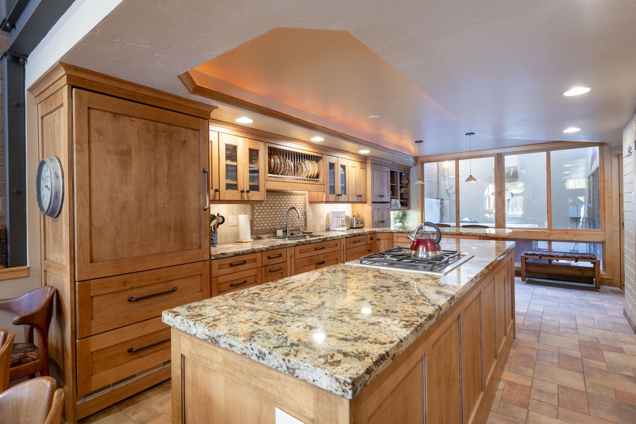 A showstopping kitchen island, warm custom cabinetry, and mountain light pouring in — Park Avenue 227 is Park City lodging at its absolute finest.
