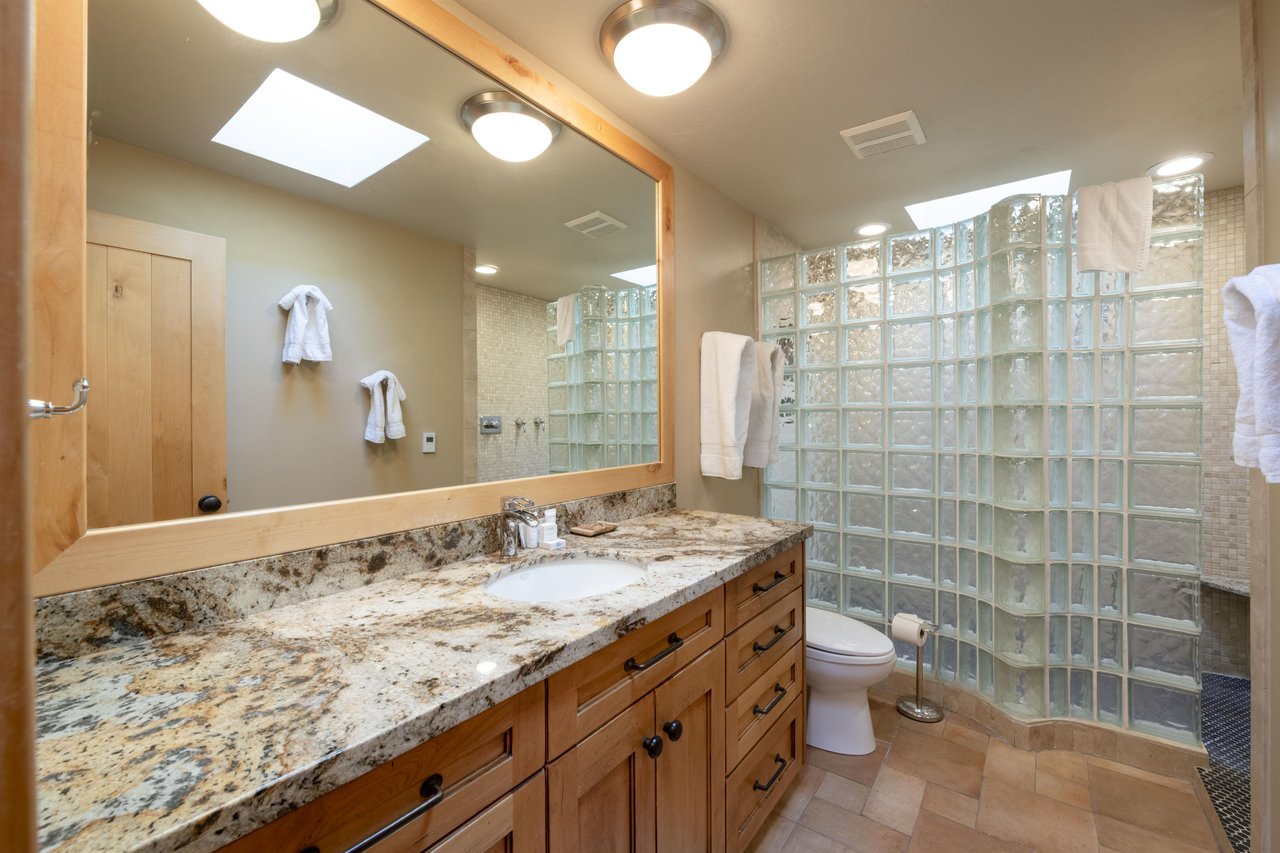Granite countertops, a glass block shower, and a skylight overhead — the bathrooms at Park Avenue 227 are a cut above the rest.