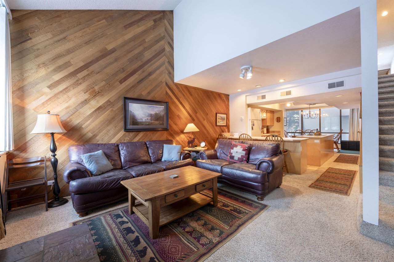 Warm wood accents, plush leather seating, and an open flow into the kitchen — Park Avenue 231 is designed for effortless mountain living.