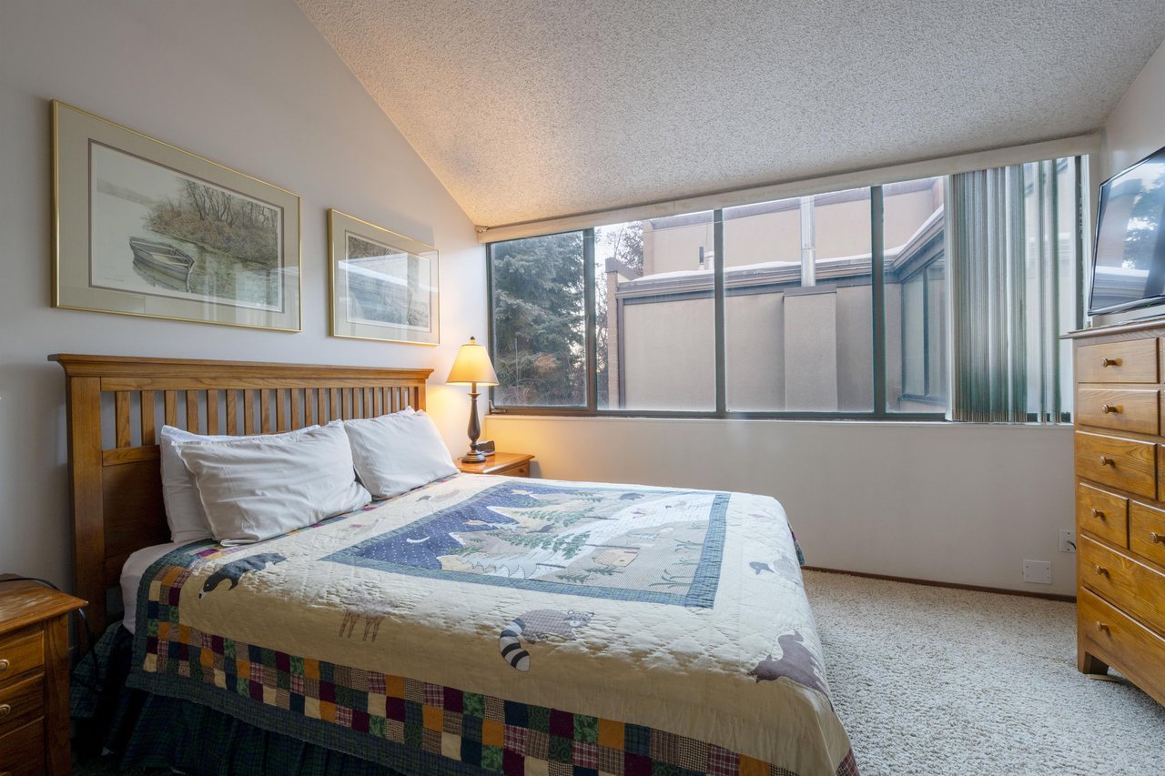 Bright windows, a cozy quilt, and the quiet of the mountains just outside — every bedroom at Park Avenue 231 is a peaceful sanctuary.