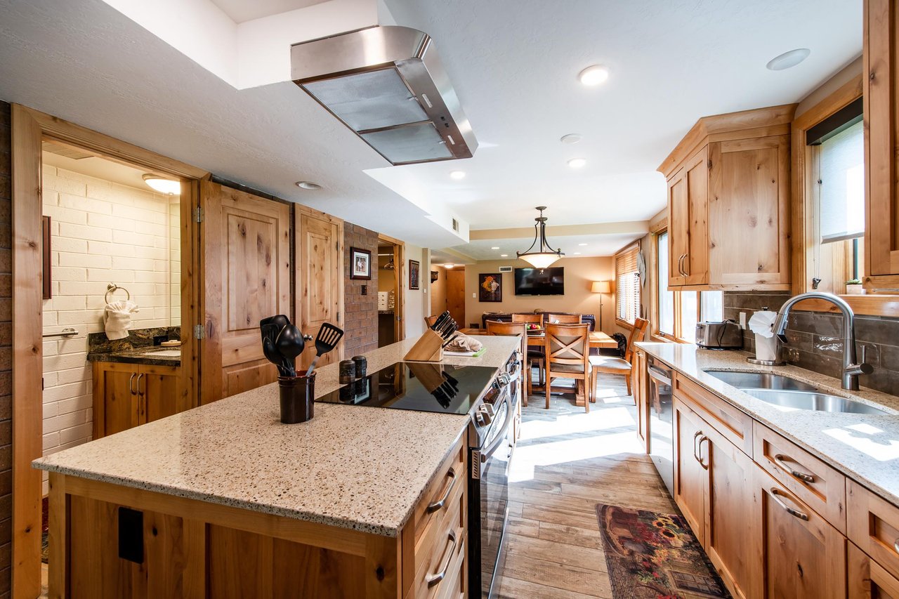 A chefs kitchen with granite countertops, premium appliances, and a seamless flow into the dining area — cooking at Park Avenue 236 is an experience in itself