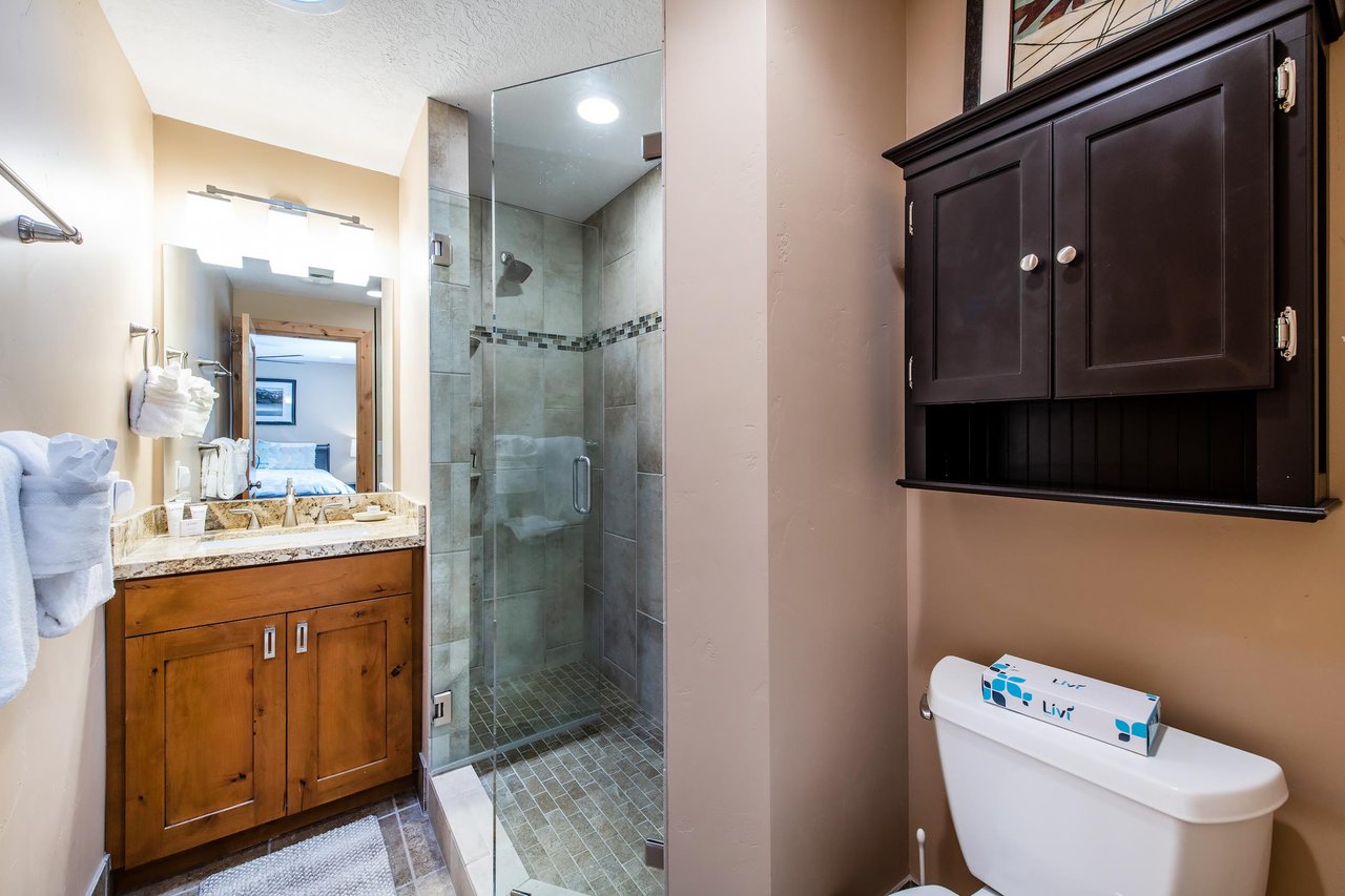 A sleek glass shower, warm wood cabinetry, and elegant tile work — the bathrooms at Park Avenue 236 are a cut above the rest.
