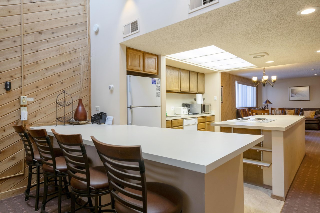 The fully equipped kitchen and breakfast bar at Park Avenue 243 make homecooked meals a breeze, adding everyday convenience to your Park City condo rental experience.