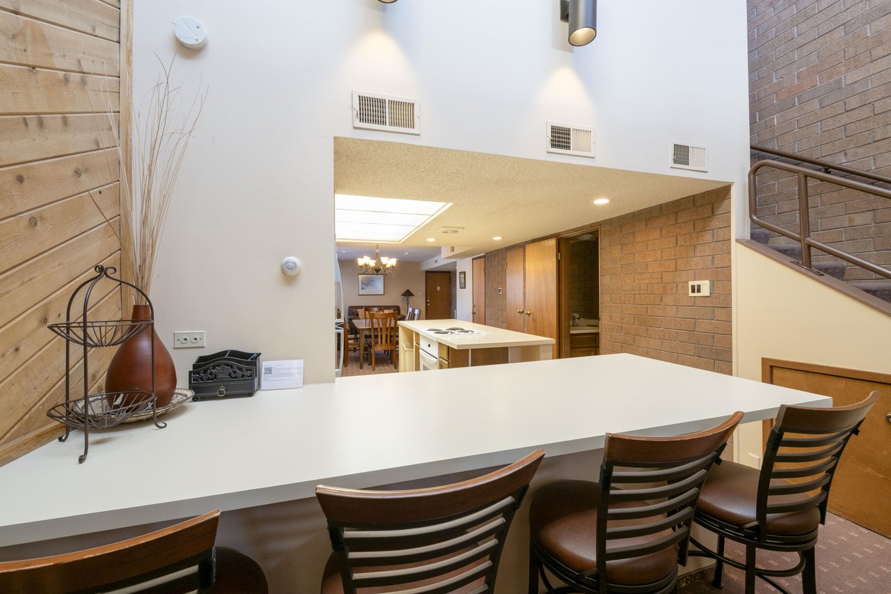Gather around the expansive kitchen bar at Park Avenue 243 — where openconcept living and modern comforts come together for the ultimate Park City condo rental experience.