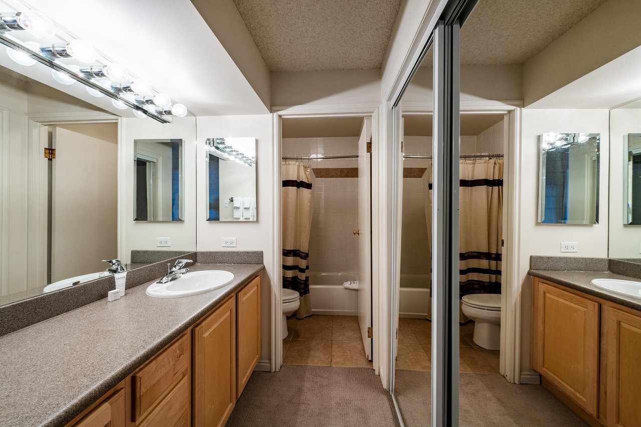 The spacious and functional bathroom at Park Avenue 251 features a generous vanity, separate shower and tub, and ample storage — providing all the practical comforts expected from premier Park City va