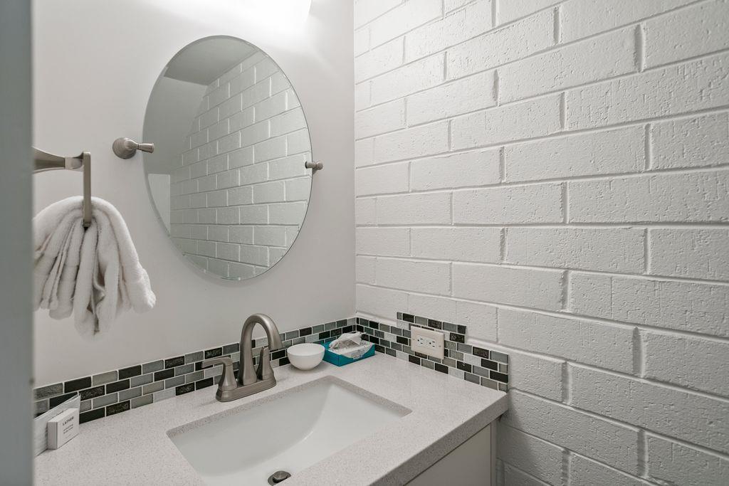 The stylish half bathroom on the main level of Park Avenue 296 features modern finishes and chic subway tile walls, adding a designer touch to this already impressive Park City vacation rental.