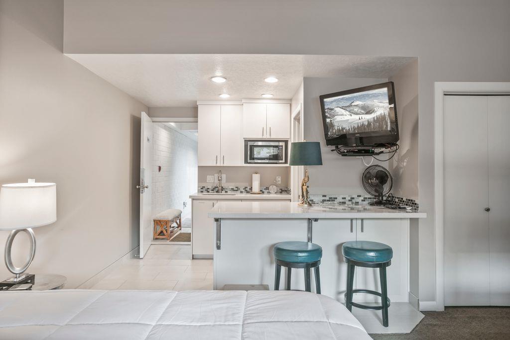The second bedroom at Park Avenue 296 offers a unique and functional layout with its own kitchenette and breakfast bar, providing added convenience and privacy for guests. A standout feature of this e