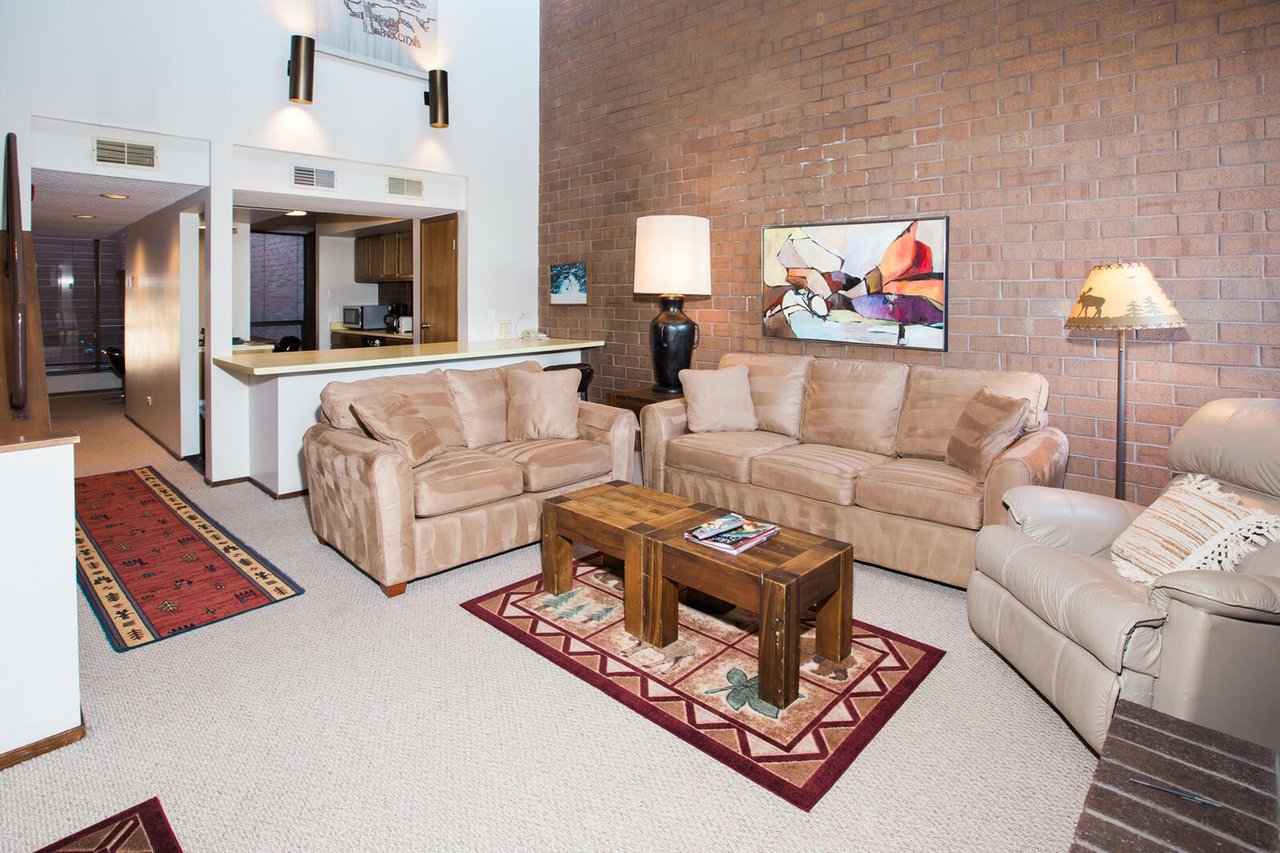 With room for everyone to relax, the open living area at Park Avenue 314 is the heart of this inviting Park City condo rental. Soaring ceilings, warm brick accents, and a cozy layout make it the perfe