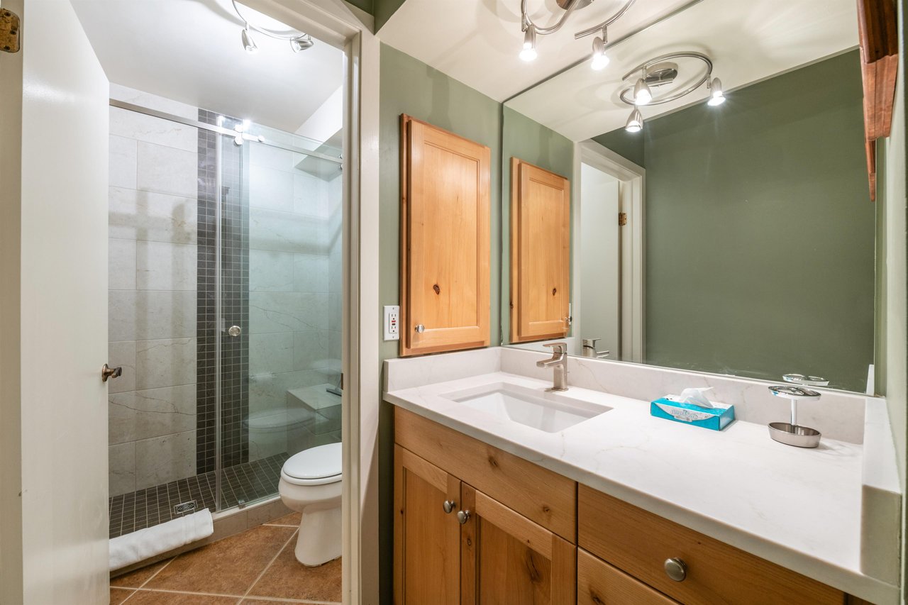 Every bathroom at Pay Day 183 is thoughtfully designed with your comfort in mind. Warm wood cabinetry, a glassenclosed shower, and a clean, fresh aesthetic — just another reason this is a standout Pa