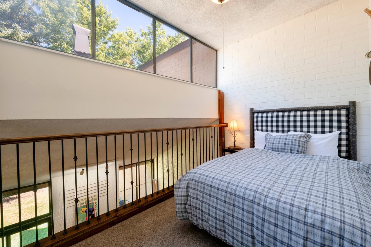 Wake up to natural light and lush treetop views in the charming queen bedroom at Park Avenue 333. The open, loftinspired layout and classic plaid bedding give this Park City condo rental a cozy yet a