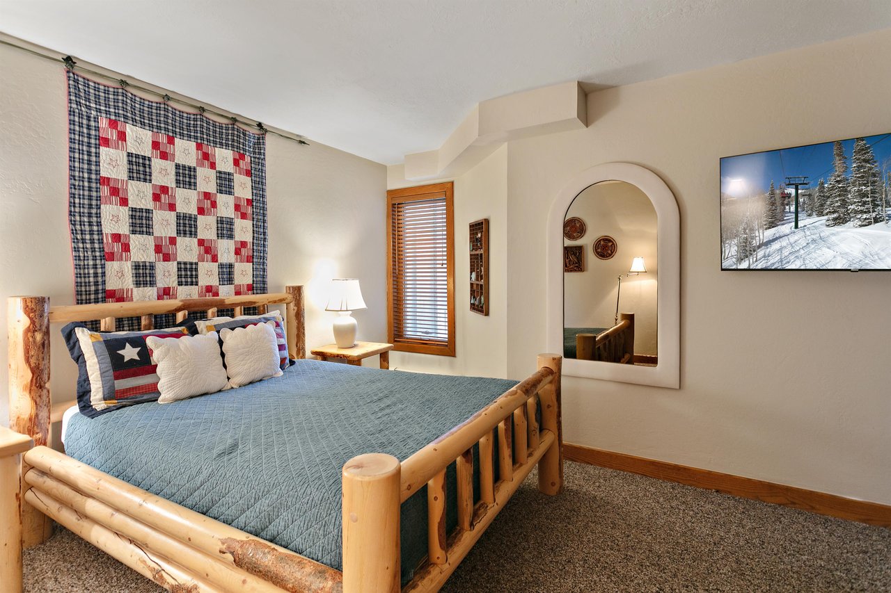 Rest and recharge in this warmly decorated queen bedroom at 1296 Pinnacle — a standout Park City lodging destination where rustic details and thoughtful design make every guest feel right at home.