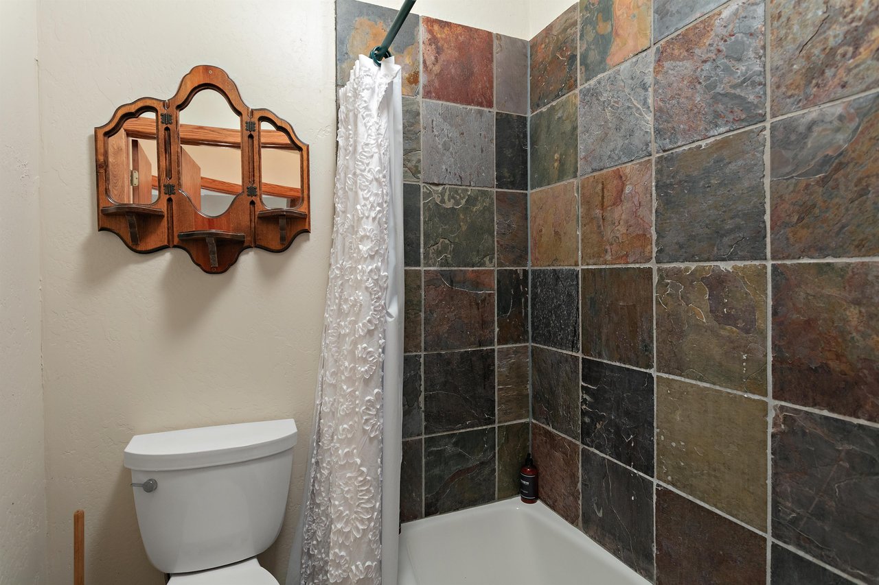 From the rich slate tile walls to the charming wooden mirror, every bathroom at 1296 Pinnacle adds a touch of mountain elegance to your Park City lodging experience.