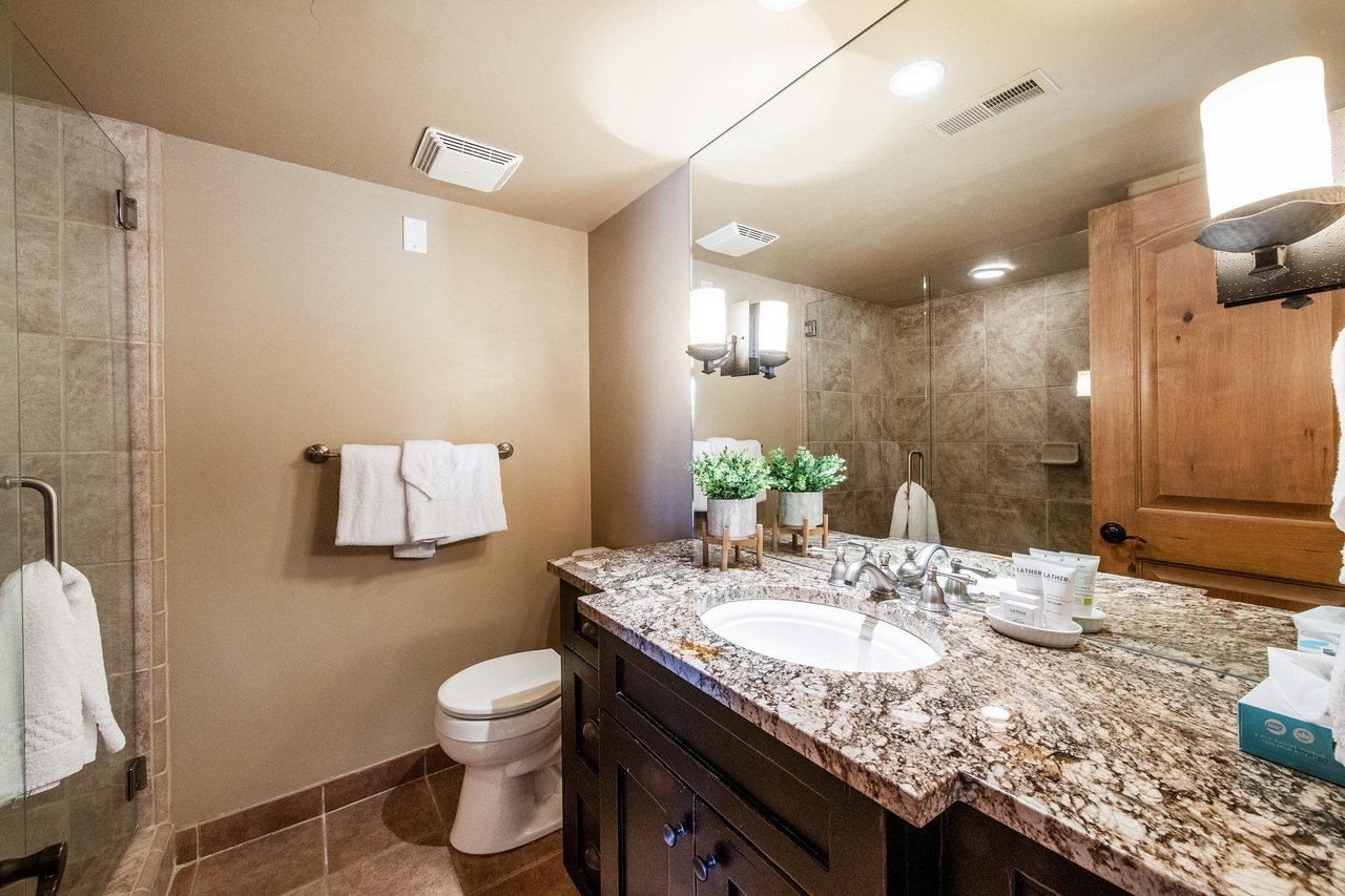 Fresh and stylish, the bathroom at Jupiter Inn 17 includes granite countertops and a walkin shower. A polished finishing touch that makes this Park City condo rental studio a cut above the rest.