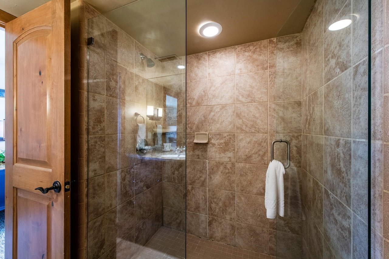 Rinse off in style in the beautifully tiled walkin shower at Jupiter Inn 17. Upscale finishes like this make this Park City condo rental a truly comfortable and memorable mountain getaway.