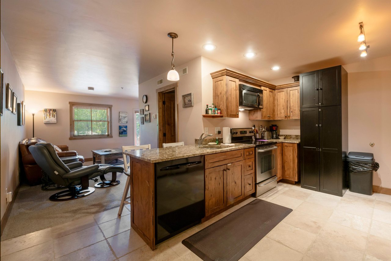 Cook and connect in the functional kitchen at Jupiter Inn 18, complete with modern appliances and an open flow to the living space. Everything you need in a comfortable Park City condo rental.