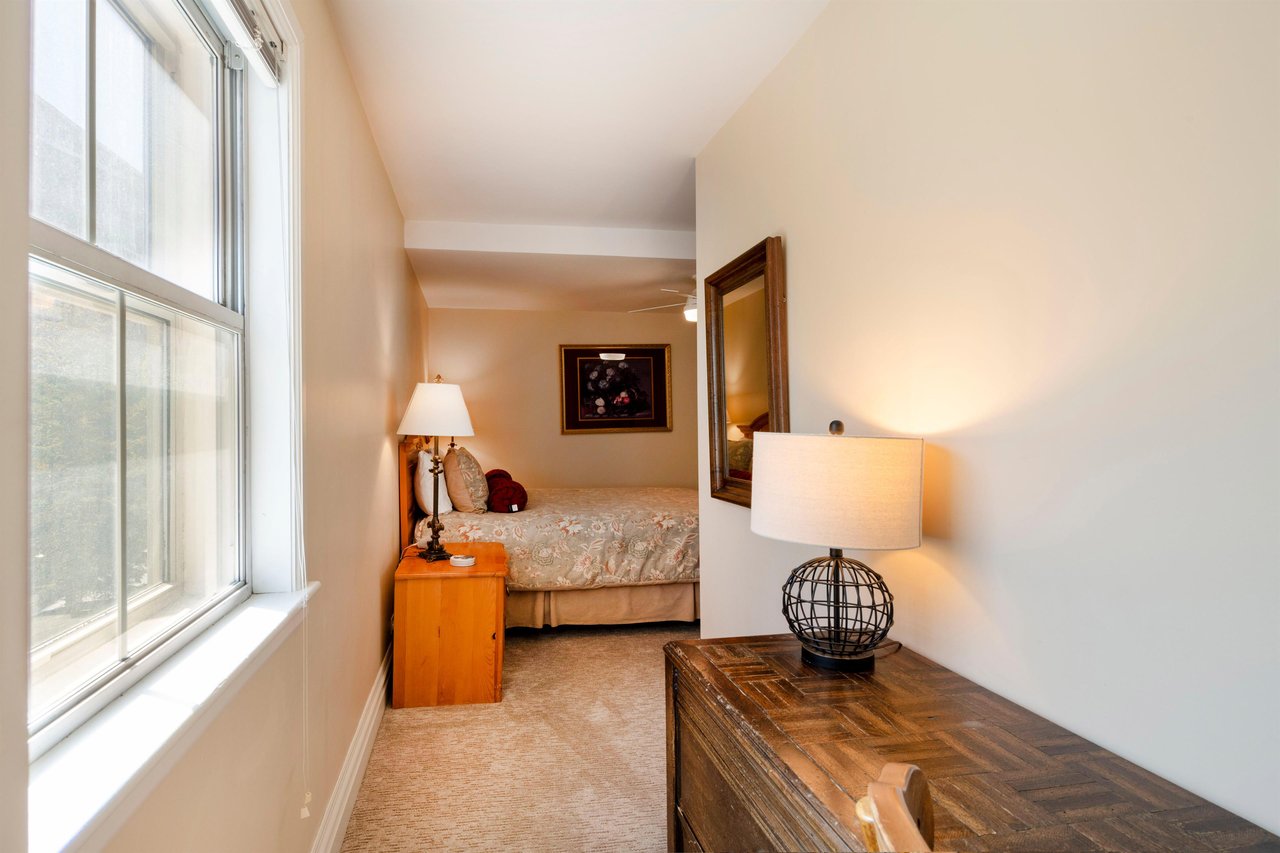 Bright and welcoming, this cozy bedroom at Resort Plaza 5004 offers a peaceful retreat with warm lighting and classic furnishings — making this Park City vacation rental a comfortable haven for every