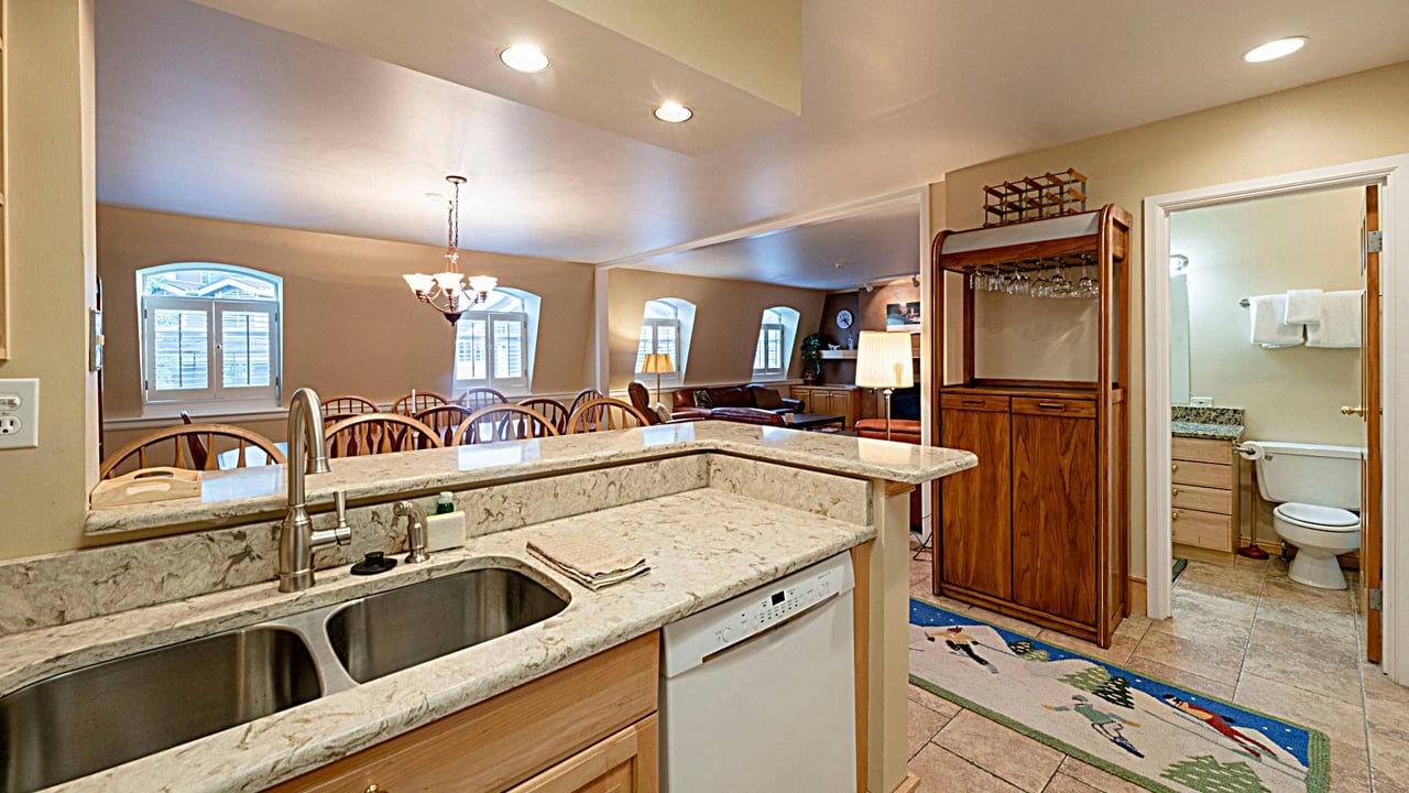 Cook and entertain with ease in the open kitchen at Resort Plaza 5013 — a wellequipped Park City vacation rental with granite countertops and seamless flow into the dining area.