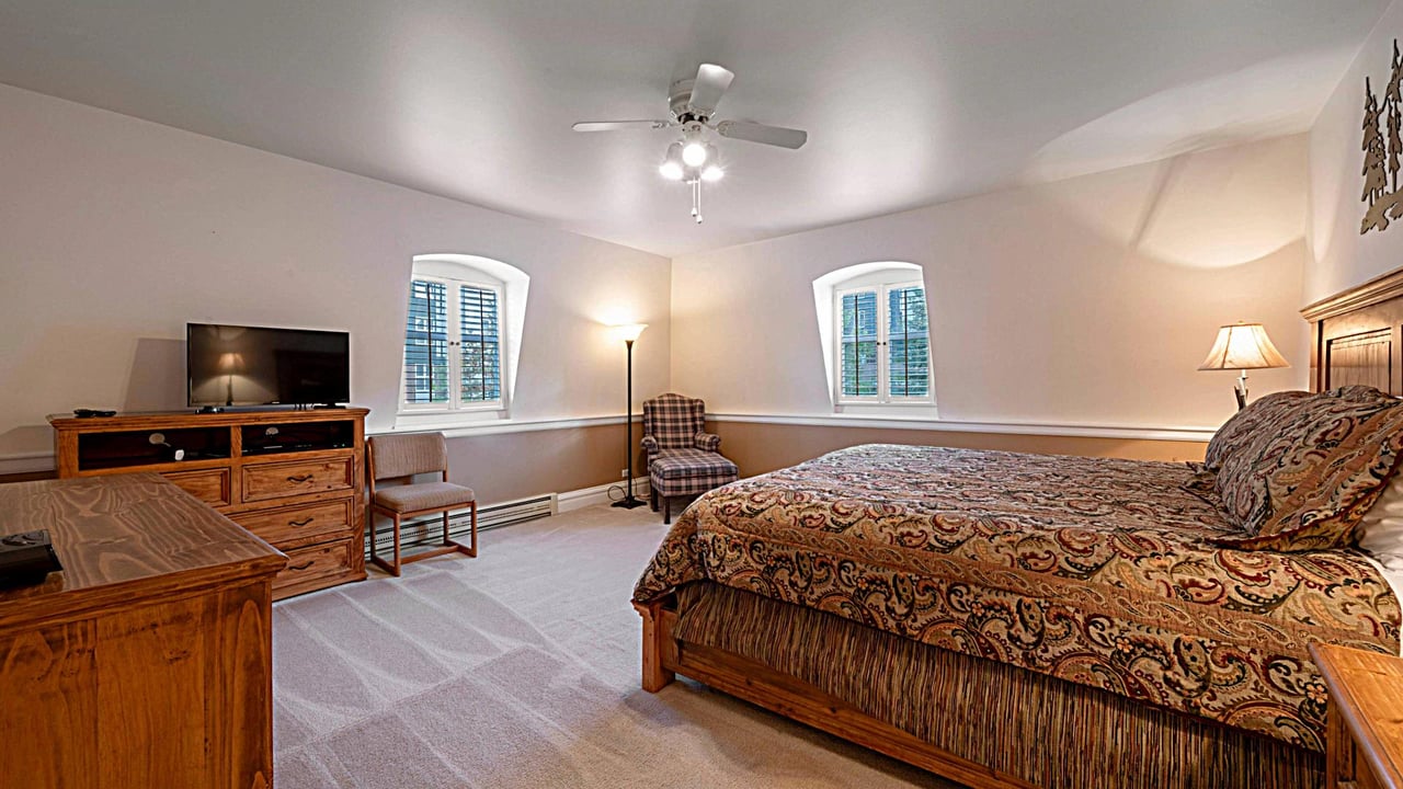 Resort Plaza 5013 offers a spacious king bedroom with natural light and cozy seating — a standout feature of this premier Park City condo rental and Park City lodging destination.
