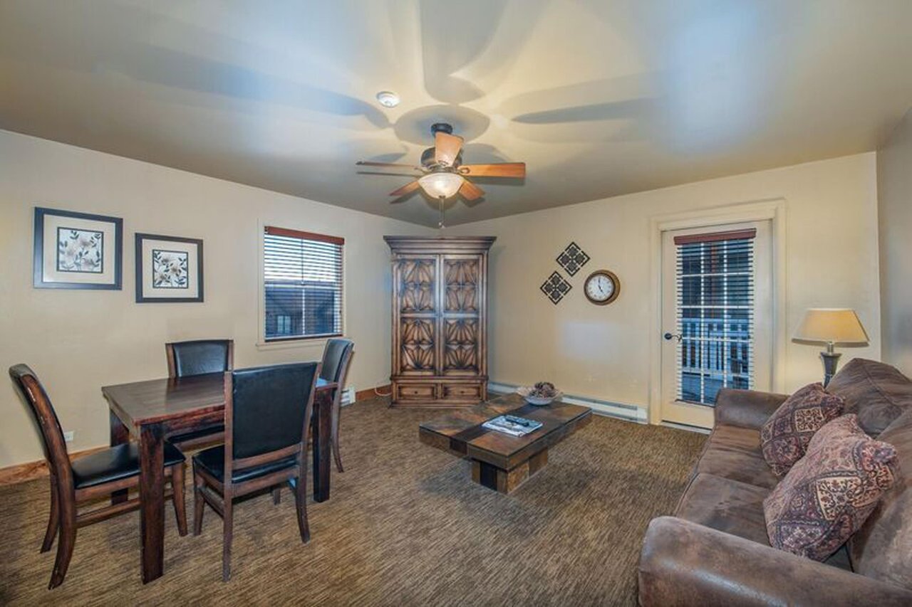 Resort Plaza 5009 offers everything you need in a Park City condo rental — a comfortable, wellappointed living space with dining area, warm lighting, and relaxed mountain charm, ideal for families an