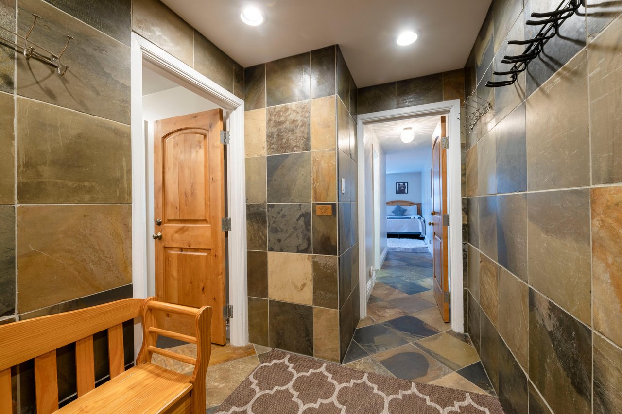 Resort Plaza 5022 welcomes guests with a striking stonetiled foyer and warm wood accents — setting the tone for an exceptional Park City condo rental and Park City lodging experience.
