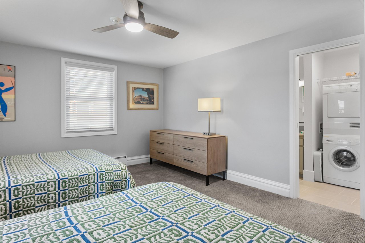 Clean, calm, and thoughtfully furnished, this relaxing bedroom features warm wood accents and plenty of space to unwind. Every detail is designed for a comfortable Park City vacation rental experience