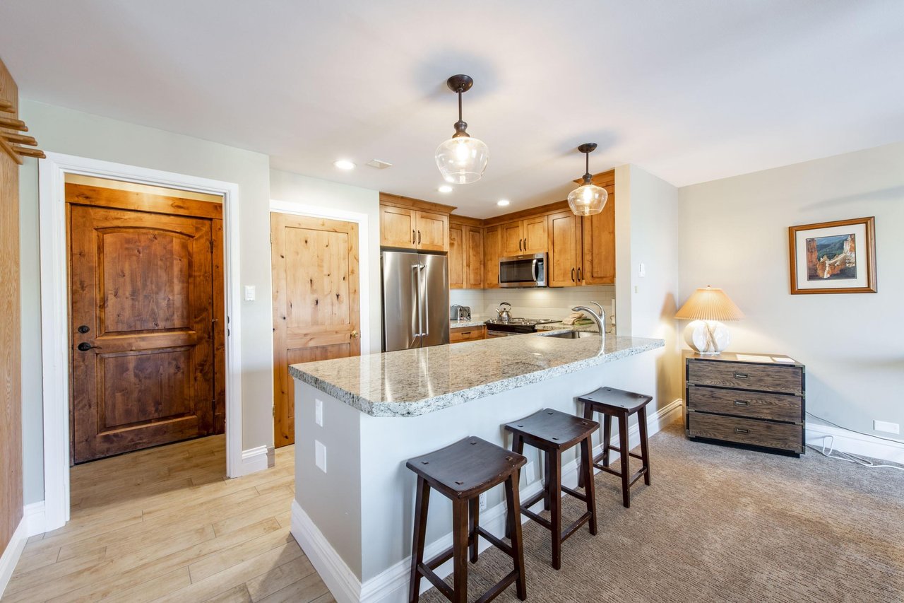 This stunning kitchen island with granite countertops and bar seating is perfect for casual meals or morning coffee before hitting the slopes. A beautiful and functional centerpiece of this Park City 