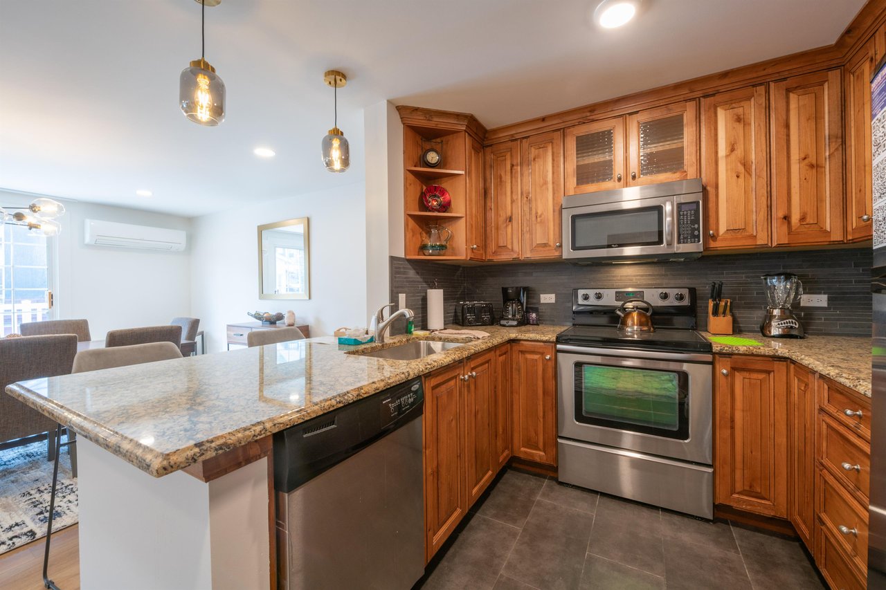 From the warm knotty wood cabinetry to the gleaming stainless steel appliances, this thoughtfully equipped kitchen has everything you need to cook and entertain with ease. A standout feature of this P