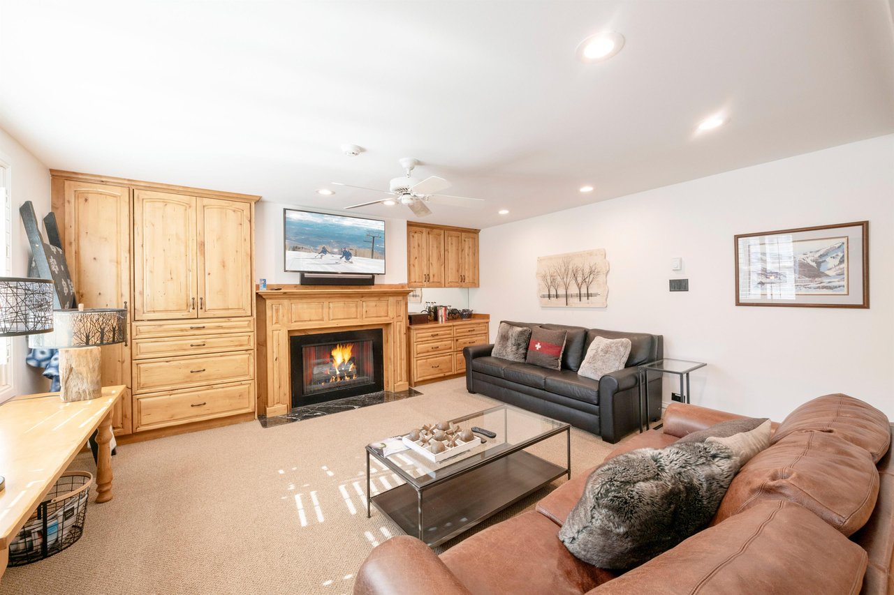 The beautiful wood cabinetry and glowing fireplace give this living room a true mountain lodge feel, offering a cozy and stylish space to unwind. Resort Plaza 5034 delivers an authentic Park City cond