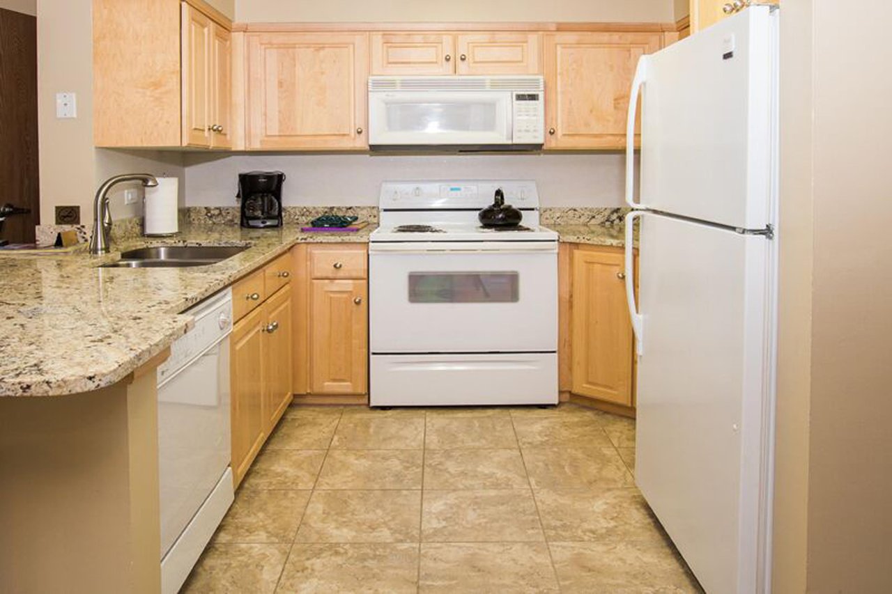 This wellequipped kitchen features light wood cabinetry, granite countertops, and a full suite of appliances, providing everything needed to prepare homecooked meals during your Park City vacation r