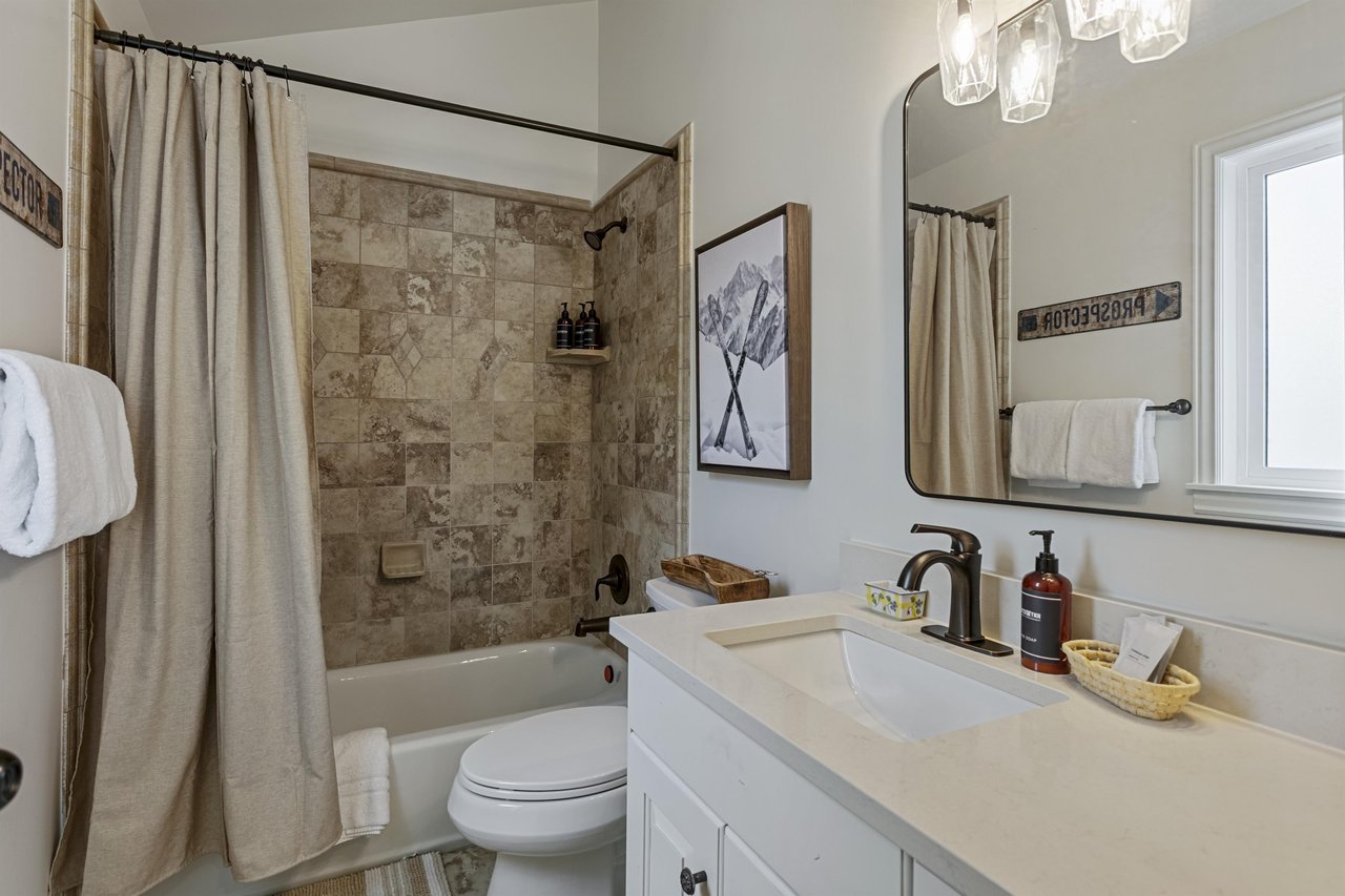 Freshen up in your bright, wellappointed bathroom with a soothing neutral palette, stone tile shower, and all the essentials—including plush towels and spainspired touches.
