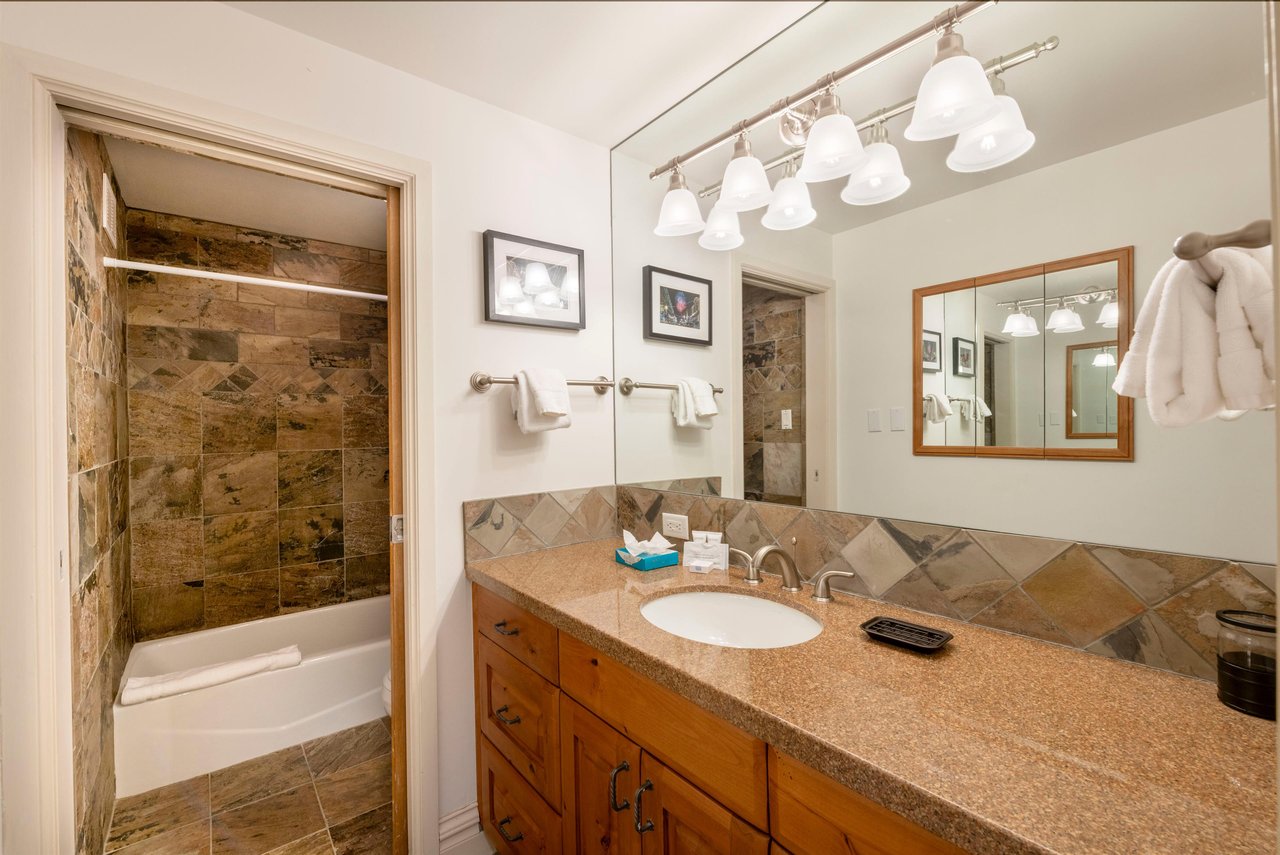 Freshen up in style at Resort Plaza 5052, where the beautifully designed bathroom with elegant finishes and modern fixtures adds an extra layer of luxury to your Park City lodging experience in the he