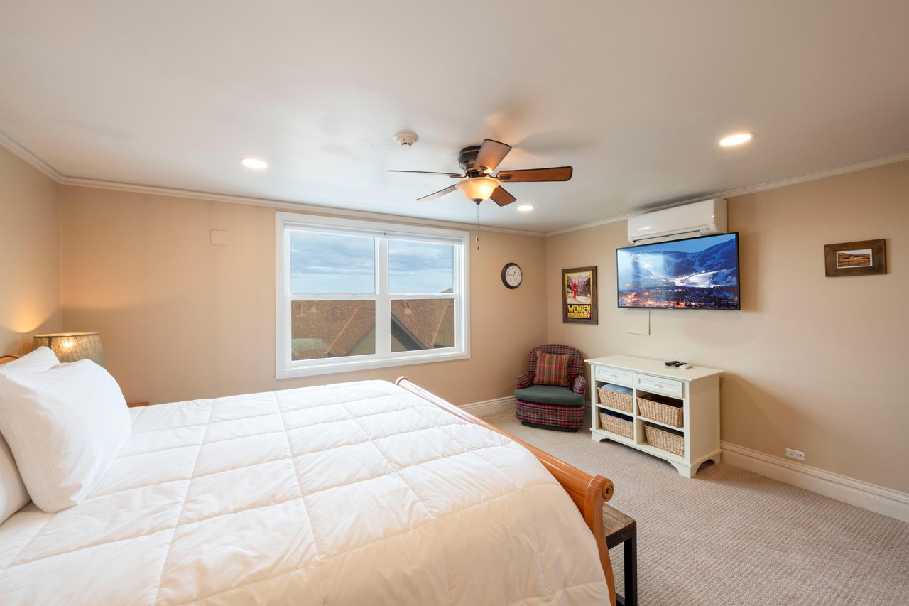 Wake up to breathtaking mountain views from the comfort of your king bedroom at Resort Plaza 5052, a Park City lodging that perfectly balances relaxation and style with modern amenities like a wallmo