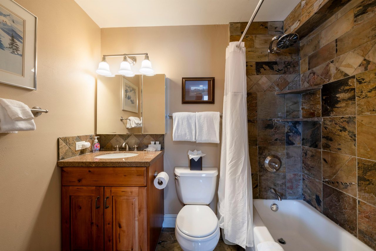 From the rustic stone shower surround to the classic wooden vanity, every bathroom at Resort Plaza 5052 reflects the warm mountain aesthetic that makes this Park City lodging such a beloved and memora