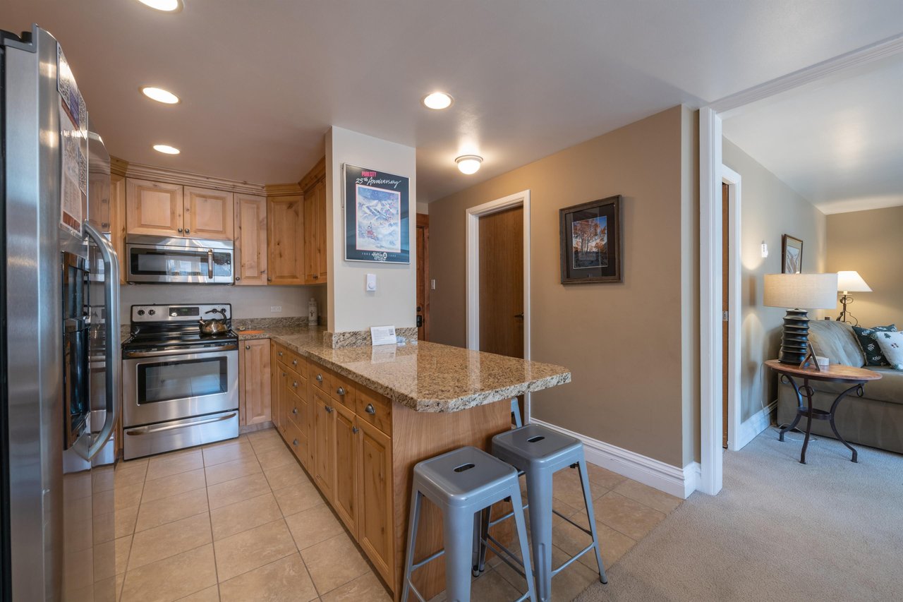The welldesigned kitchen island and breakfast bar at Resort Plaza 5064 offer the perfect spot for casual dining and conversation, adding to the warm and functional appeal of this outstanding Park Cit