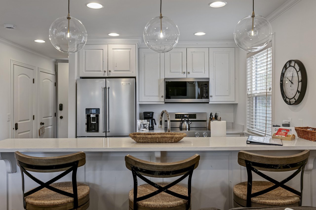 Cooking is a pleasure at Three Kings 83 — bright white cabinetry, a generous island, and modern finishes elevate every meal in this Park City condo rental.