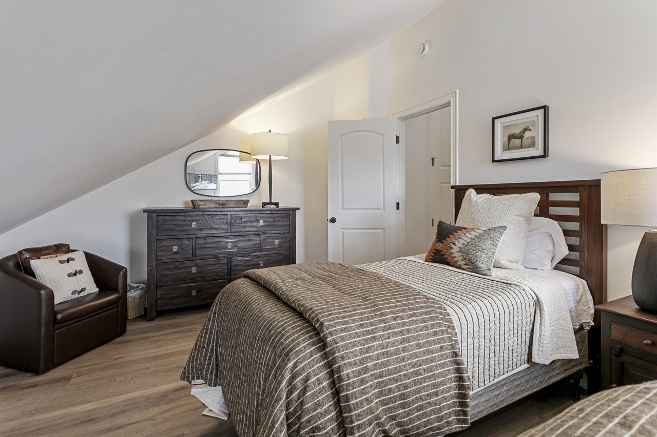A peaceful upperlevel bedroom at Three Kings 83 offers privacy and style — newly furnished and ready for restful nights.