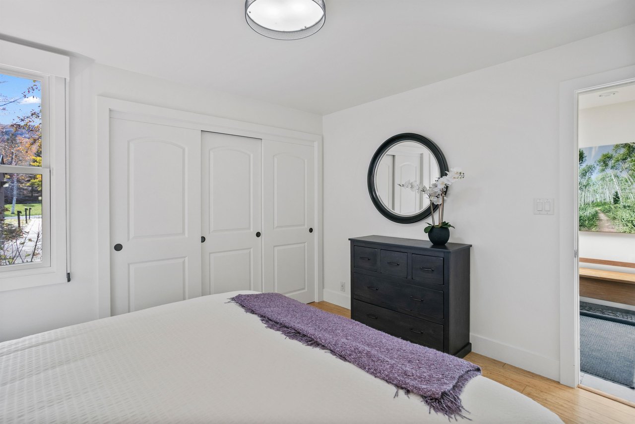 Three Kings 64 offers a bright and beautifully appointed bedroom with generous closet space, elegant dark wood furnishings, and a clean, modern aesthetic that makes this Park City vacation rental the