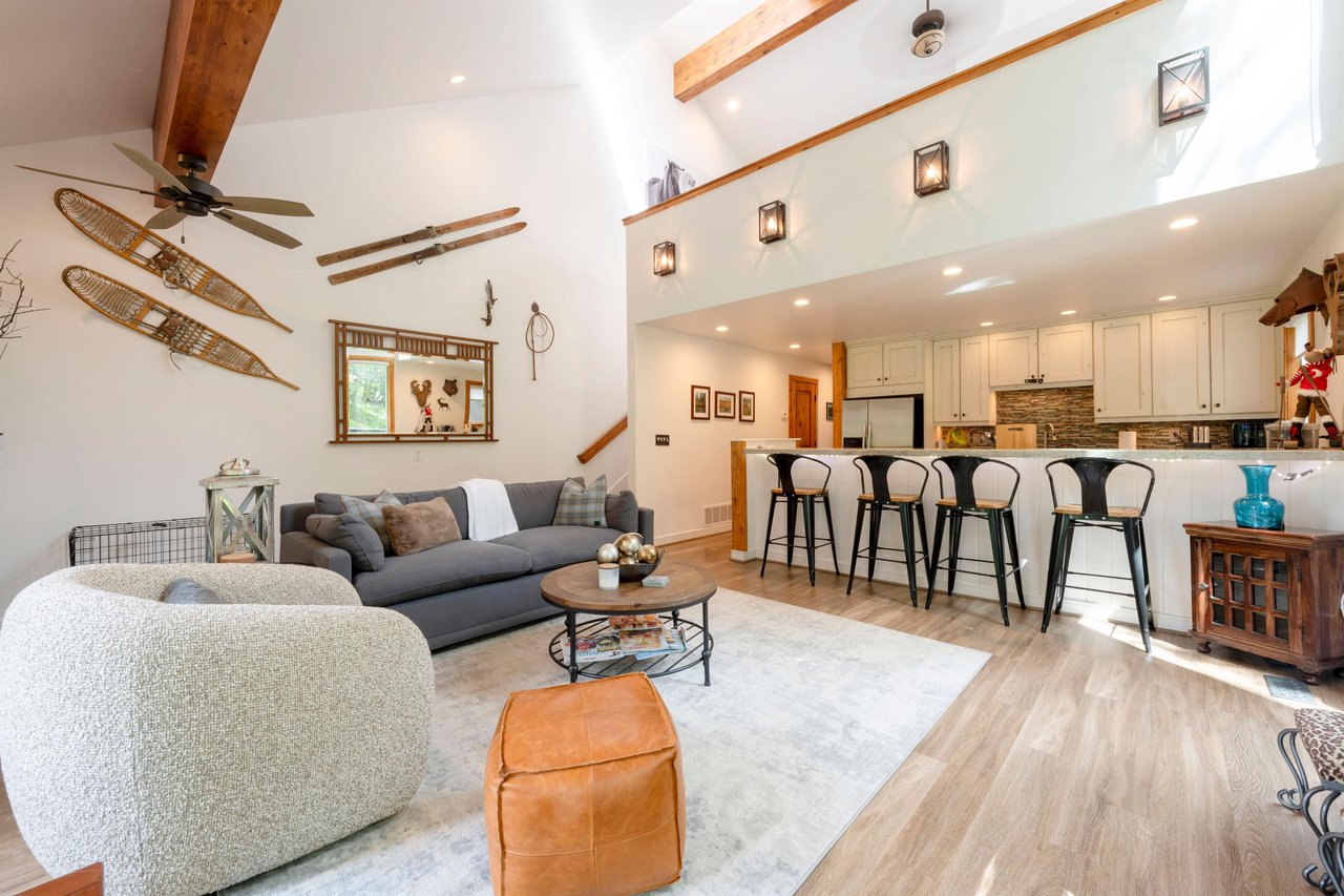 Three Kings 93 offers a beautifully open living and kitchen space with soaring beamed ceilings and warm, inviting décor — the perfect setting for a memorable Park City condo rental getaway