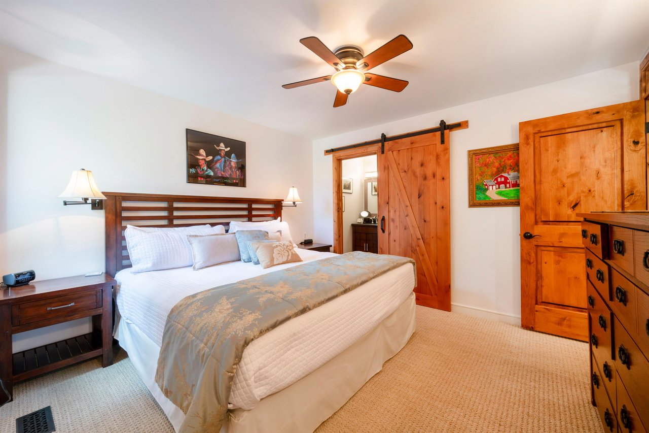 Three Kings 93 offers a beautifully appointed king bedroom complete with a charming rustic barn door and warm mountain décor — a cozy and restful retreat within this premier Park City vacation rental.