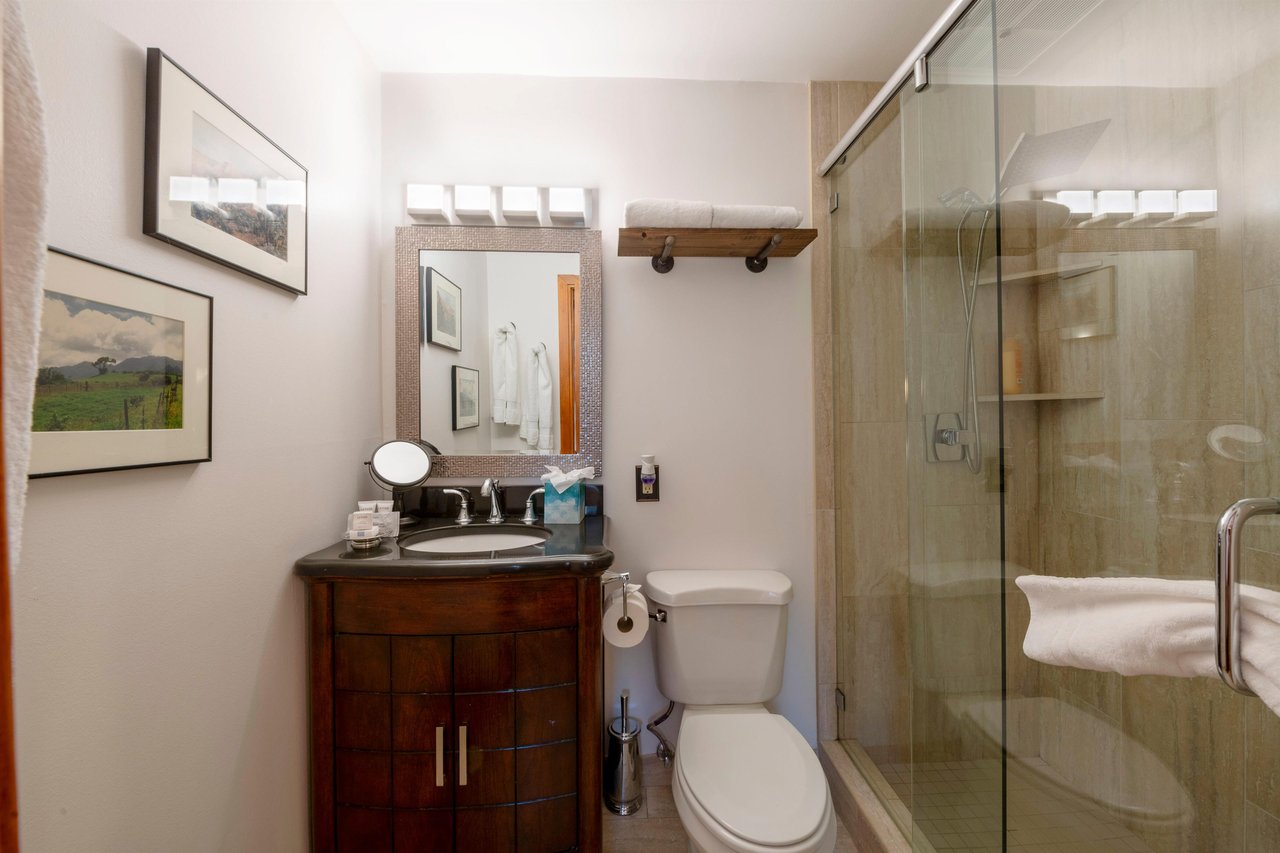 Three Kings 93 features beautifully finished bathrooms with rich wood vanities, a walkin glass shower, and rustic accents that perfectly complement the mountain character of this exceptional Park Cit