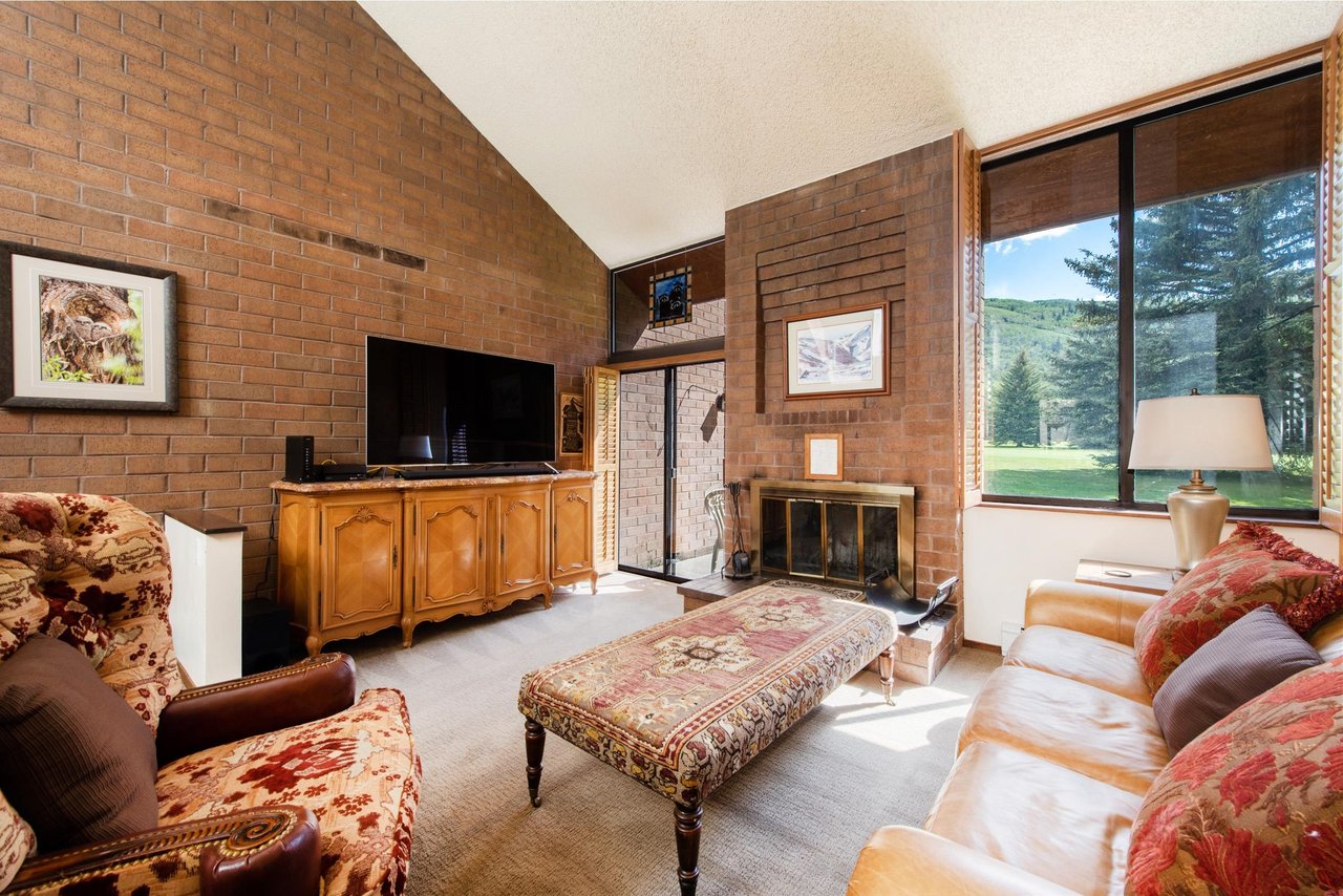 Rustic brick, vaulted ceilings, and sweeping golf course views from your Park Avenue 267 rental.