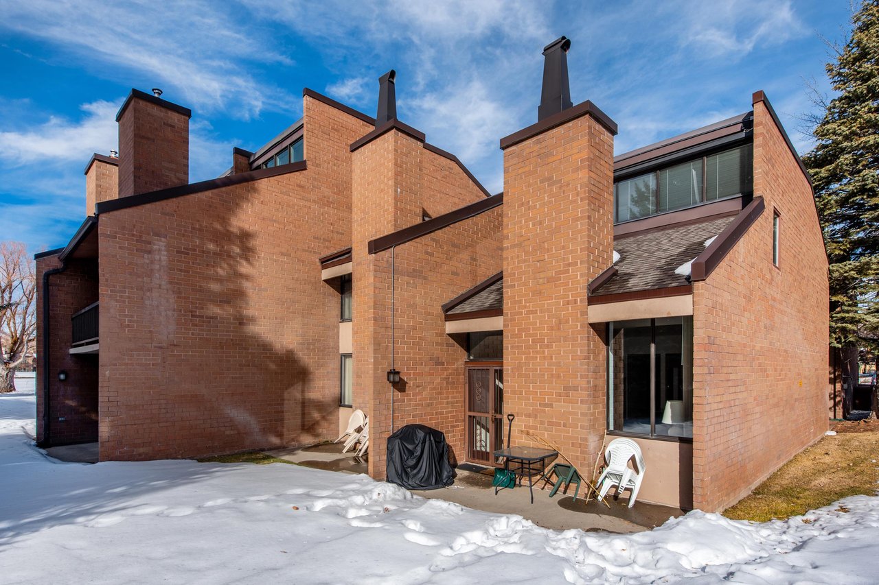 The brick exterior of Park Avenue 268 with carport parking.